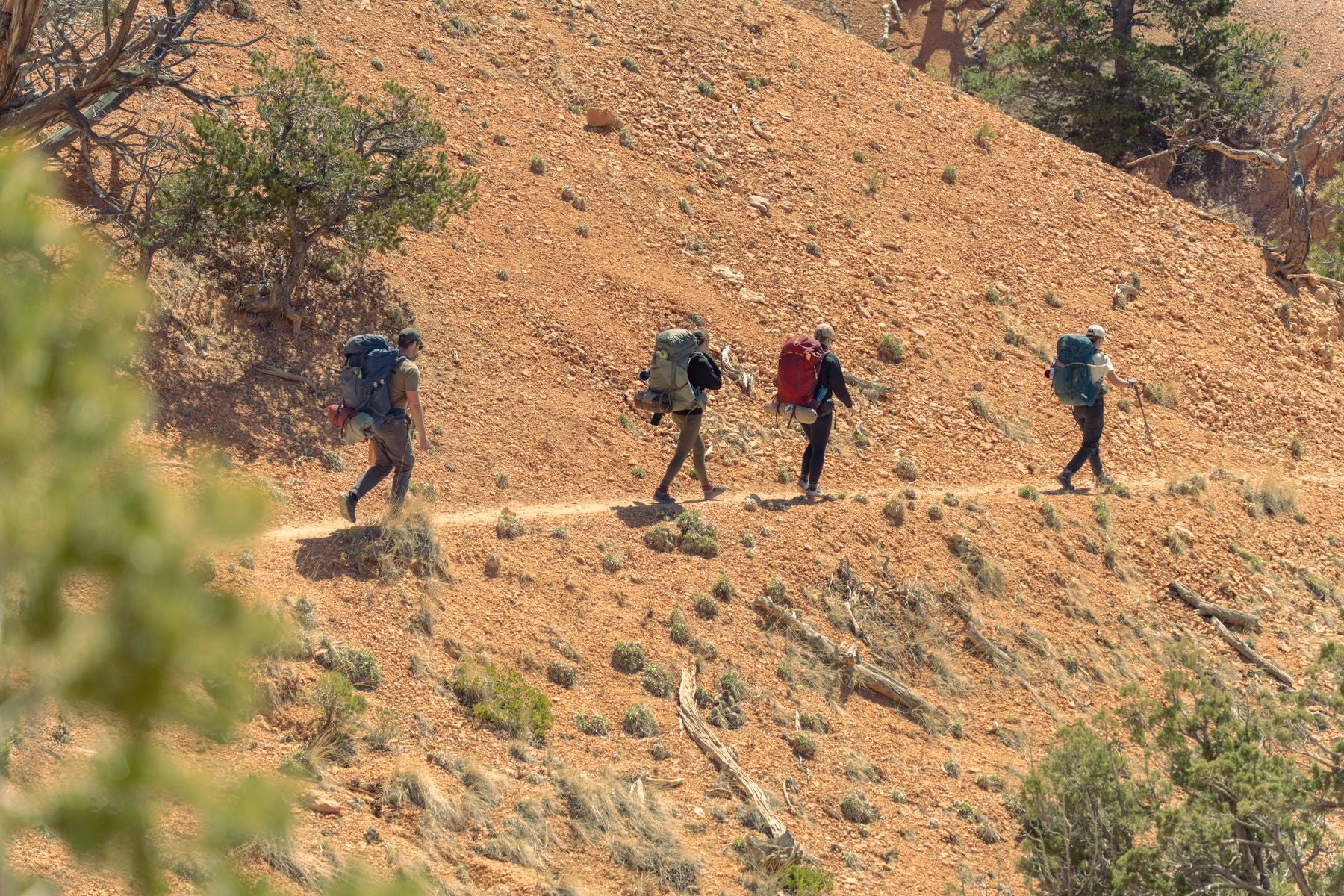 Backpackers crossing rugged outdoor terrain