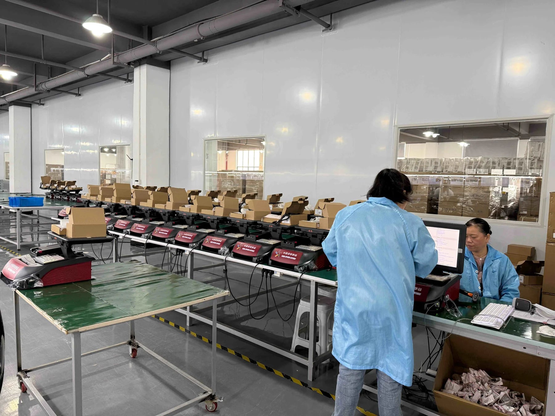 Production staff operating a multi-station inspection line at the Hunan base